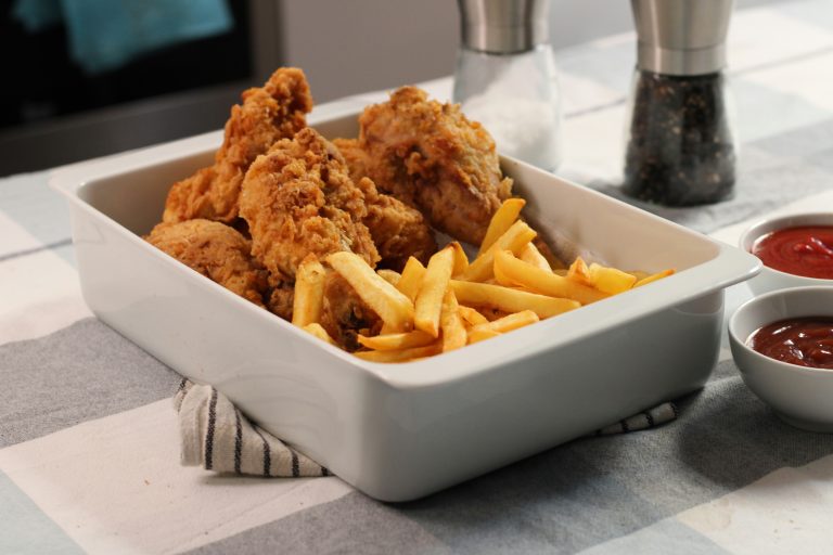 Golden, crispy fried chicken served diner-style with fries and classic American comfort food sides.